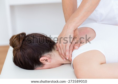 Physiotherapist doing shoulder massage in medical office
