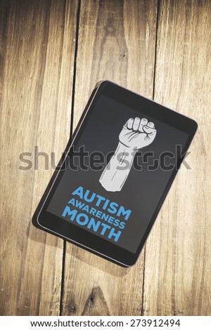 Autism awareness month against overhead of tablet on desk