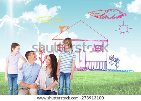 Family smiling while looking at each other against blue sky over green field
