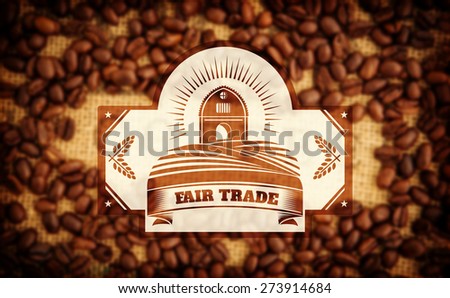 Fair Trade graphic against coffee beans surrounding coffee stamp on sack