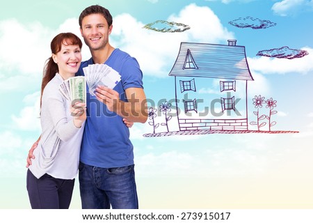 Couple holding fans of cash against blue sky