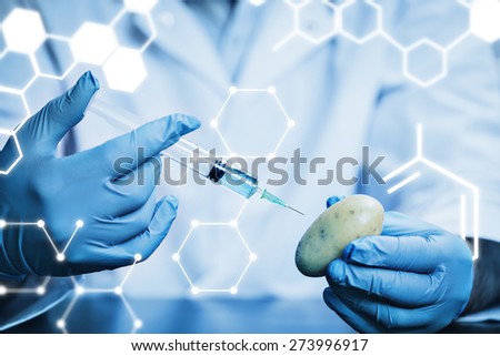 Science graphic against food scientist injecting a potato
