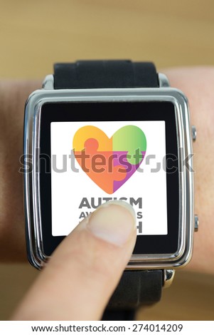 Businesswoman with smart watch on wrist against autism awareness month