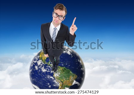 Geeky hipster businessman with finger up against blue sky over clouds