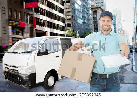 Delivery man with package giving clipboard for signature against new york street