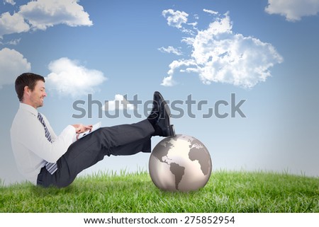 Businessman using tablet against field and sky