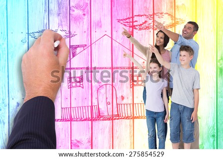 Family of four pointing at copy space against digitally generated grey wooden planks