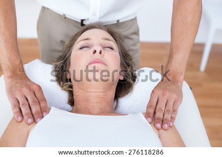 Woman receiving shoulder massage in medical office