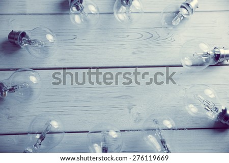 Light bulbs forming frame on wooden table