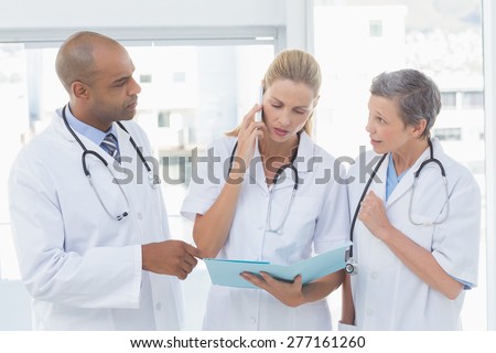 Doctors having an important phone call in medical office