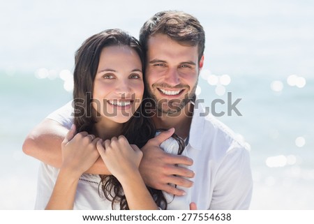 happy couple smiling at the beach