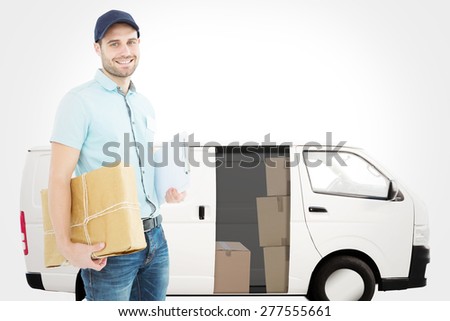 Portrait of happy courier man with parcel against white delivery van
