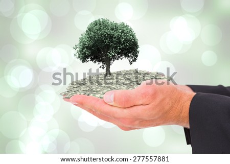 Businessman holding his hands out against grey abstract light spot design