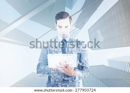 Businessman holding a tablet computer against high angle view of city