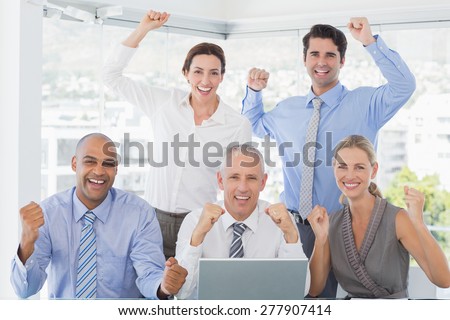 Business team celebrating a good job in the office