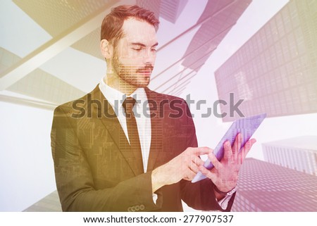 Cheerful businessman touching digital tablet against room with large window looking on city