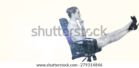 Businesswoman sitting on swivel chair with feet up against new york
