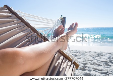 Woman relaxing in the hammock at the beach