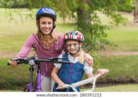 Mother and her daughter on their bike on a sunny day