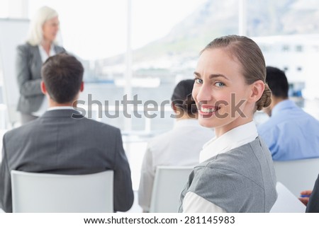 Businesswoman looking at camera during meeting in meeting room