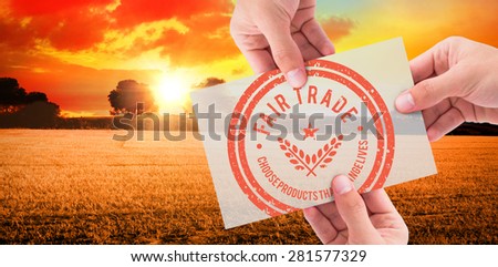 Hand showing card against countryside scene