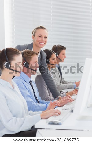 Manager checking the work of the staff in call center