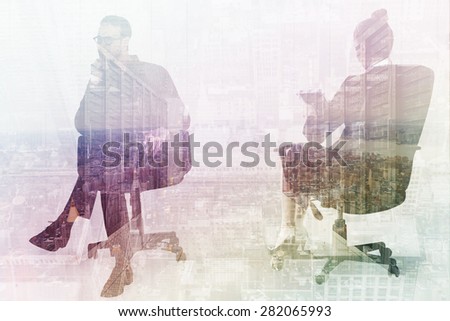 Thoughtful businessman sitting on a swivel chair against server room with towers