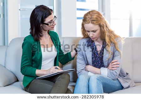 Psychologist comforting a depressed patient in the office