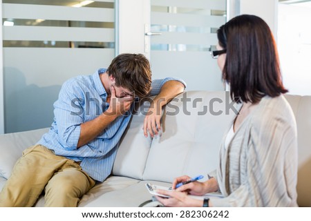 Psychologist talking with depressed man in the office