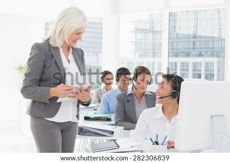 Businesswoman speaking with her colleagues in office