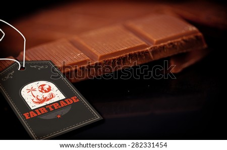 Fair Trade graphic against chocolate bar lying on chocolate