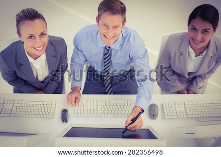 Businessman showing his screen to the team in office