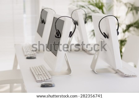 Computers and headsets in empty office