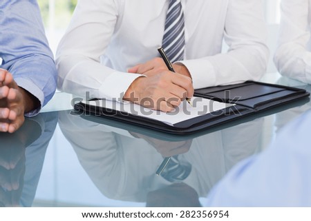 Businessman taking notes at conference in the meeting room