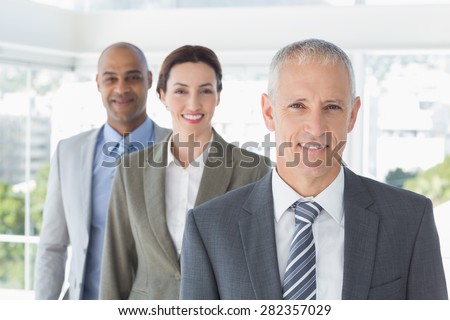 Business colleagues smiling at camera in the office