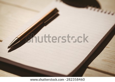 Empty notepad with pen on a desk