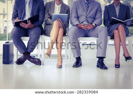 Business people waiting to be called into interview at the office