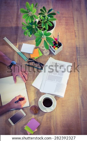Designer working at desk overhead shot in creative office