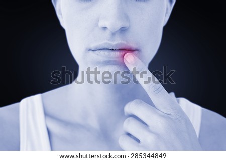 Pretty woman with finger on lip against blue background with vignette