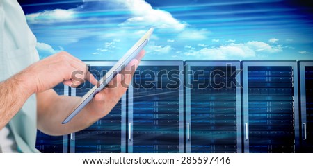 Man using tablet pc against composite image of server towers