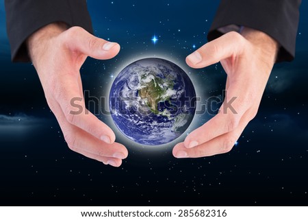 Businessman holding hand out in presentation against stars twinkling in night sky