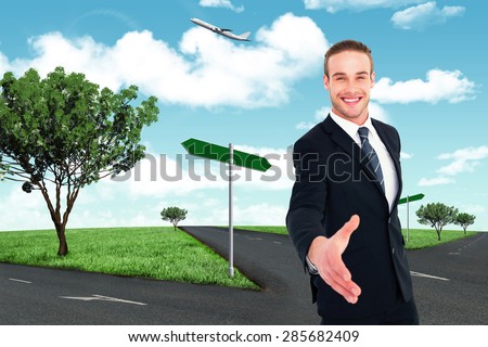 Businessman smiling and offering his hand against road leading out to the horizon