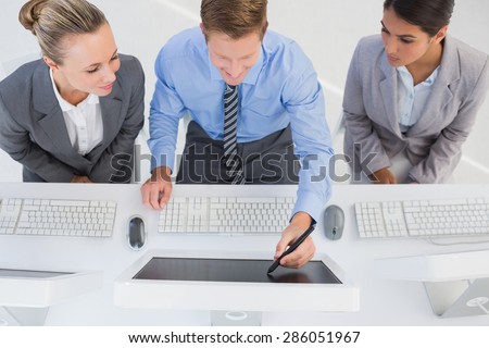 Businessman showing his screen to the team in office