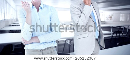 Smiling businesswoman looking at camera against empty class room