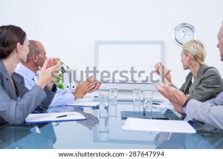 Business team looking at white screen in the meeting room