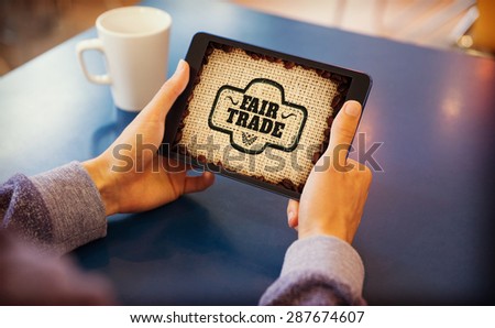Man using tablet pc against fair trade