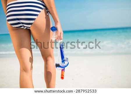 Rear view of woman looking at the ocean on the beach