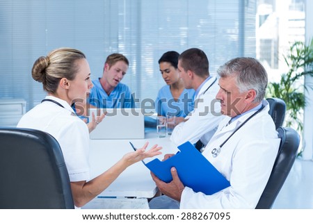 Team of doctors working on their files in the meeting room