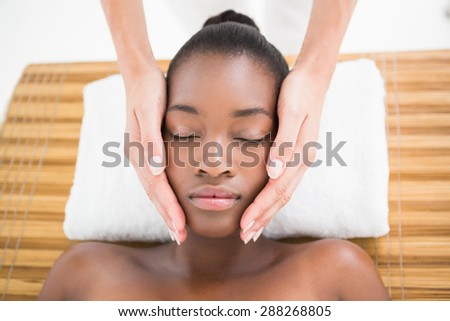 Pretty woman enjoying a head massage at the health spa