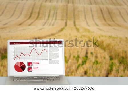 Business interface with graphs and data against rural fields